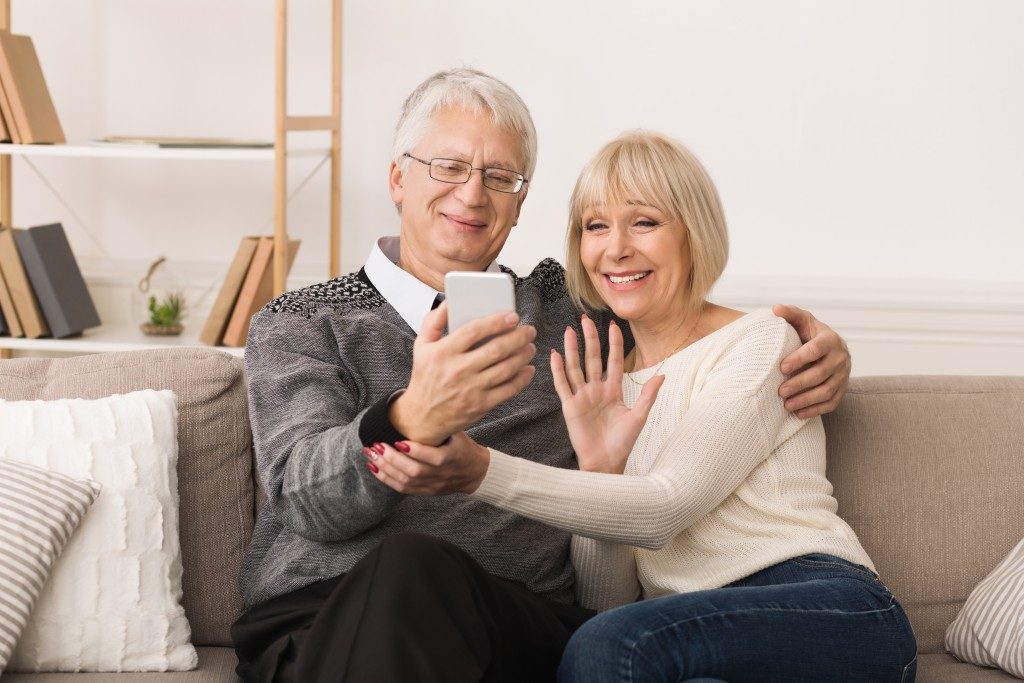 an old couple enjoying a video together